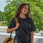 Lady standing with bag with Body Mechanic teeshirt