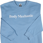 Light blue sweatshirt with 'Body Mechanic' text on a white background
