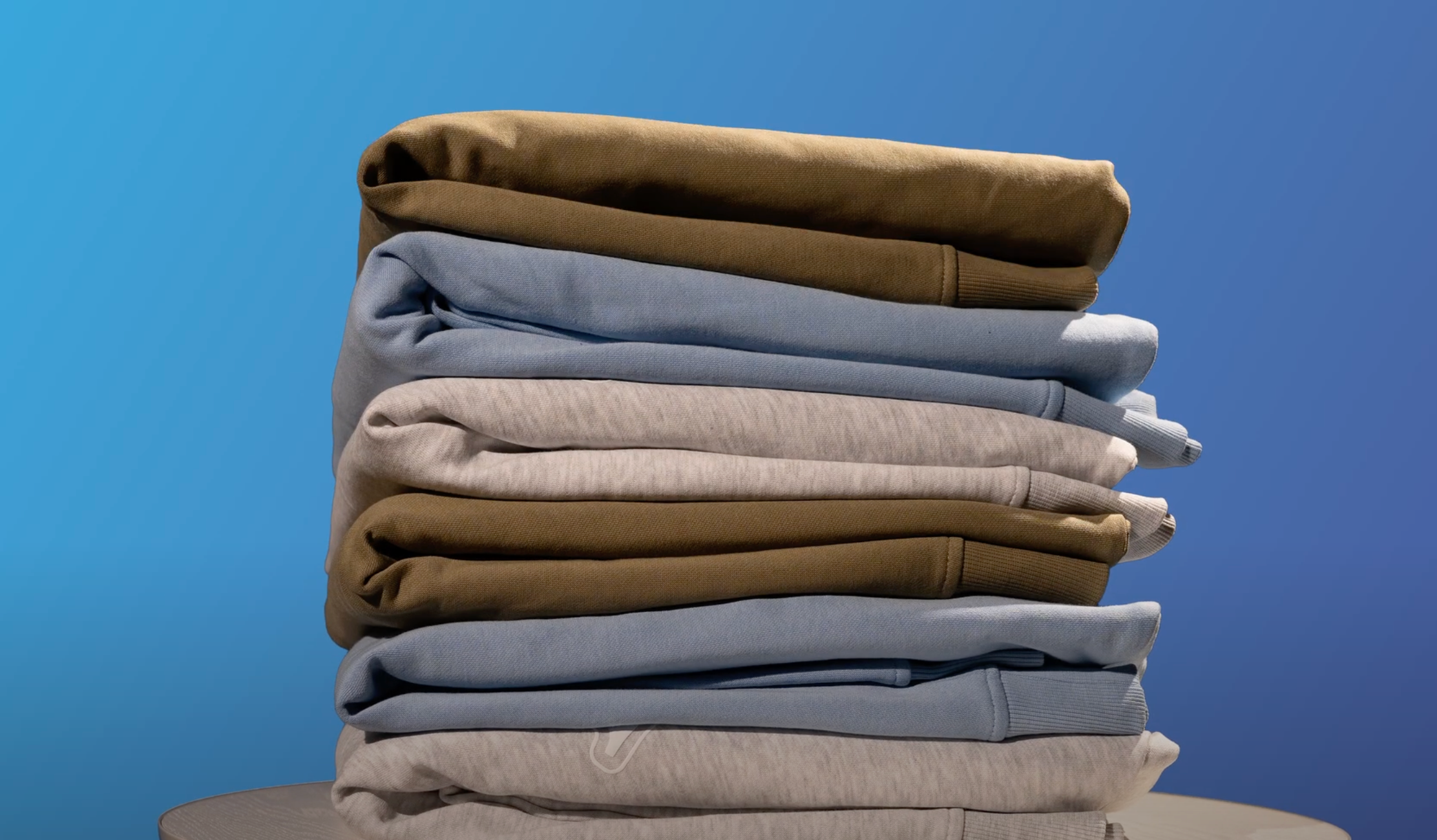 Stack of folded clothes on a blue background